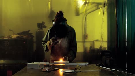 Female-welder-welding-a-metal