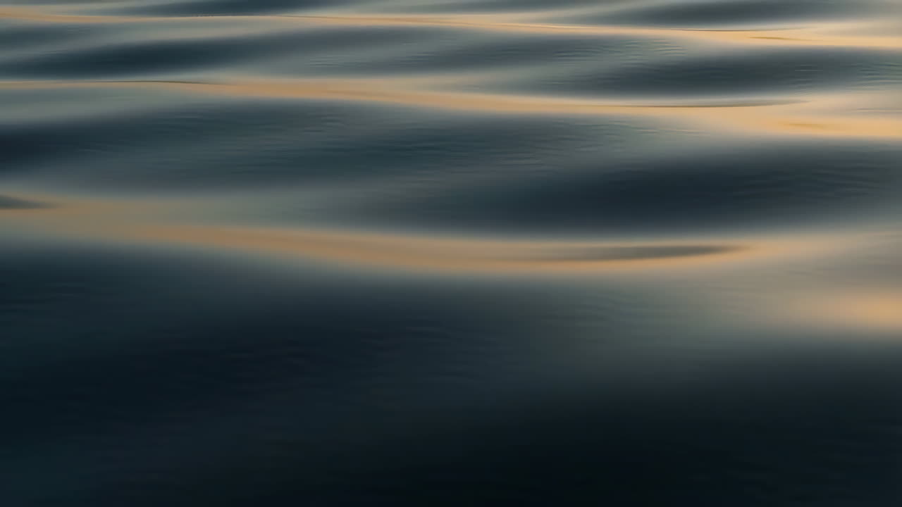 Golden Reflections on Dark Water Ripples