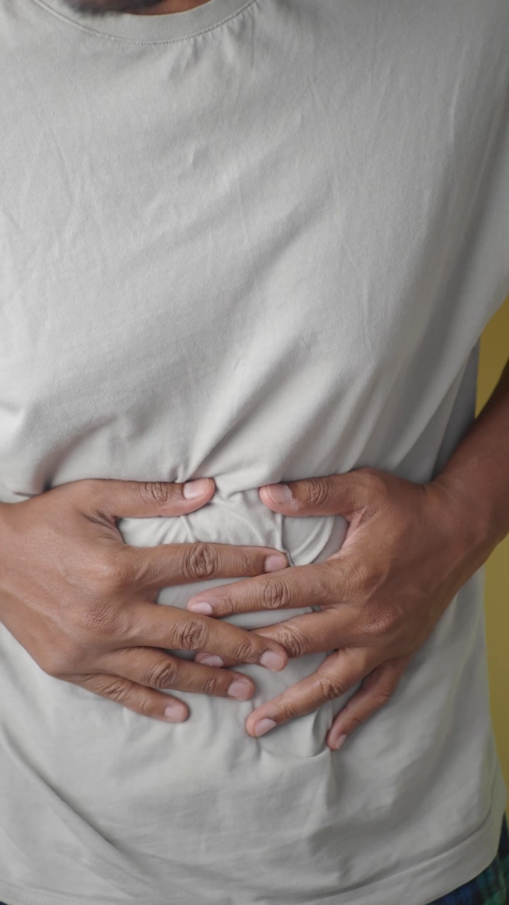 Close-up of Person Suffering from Stomach Ache