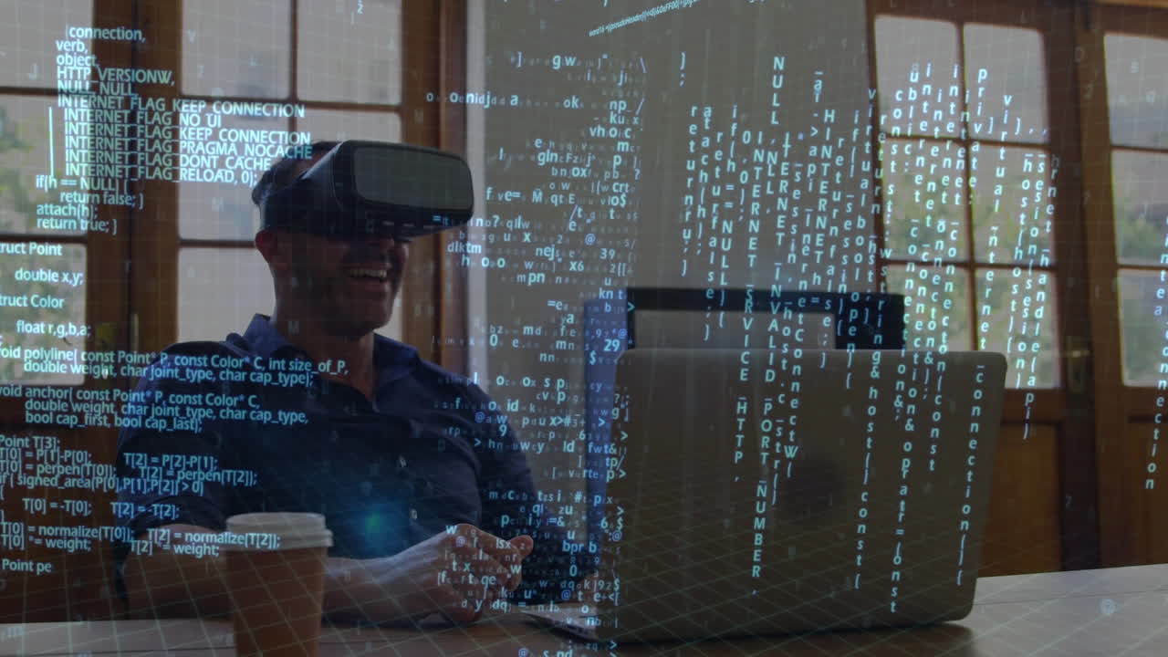 Man wearing virtual goggles while using a laptop