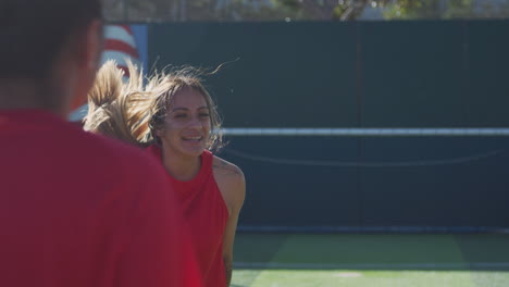 player heading ball as female soccer team warm up during training before match