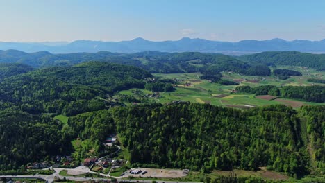 forward moving aerial footage over the green dense tall trees surrounding the plateau, representing serene and calm landscape