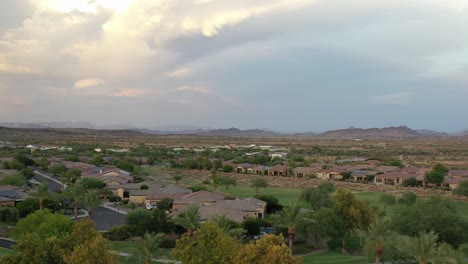 A-drone-rises-up-to-reveal-a-stunning-skyline-of-luxury-resort-homes-and-the-mountains-along-a-beautiful-horizon