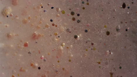gross colored orbs moving in swampy liquid texture background