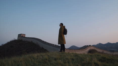 man standing at the great wall of china