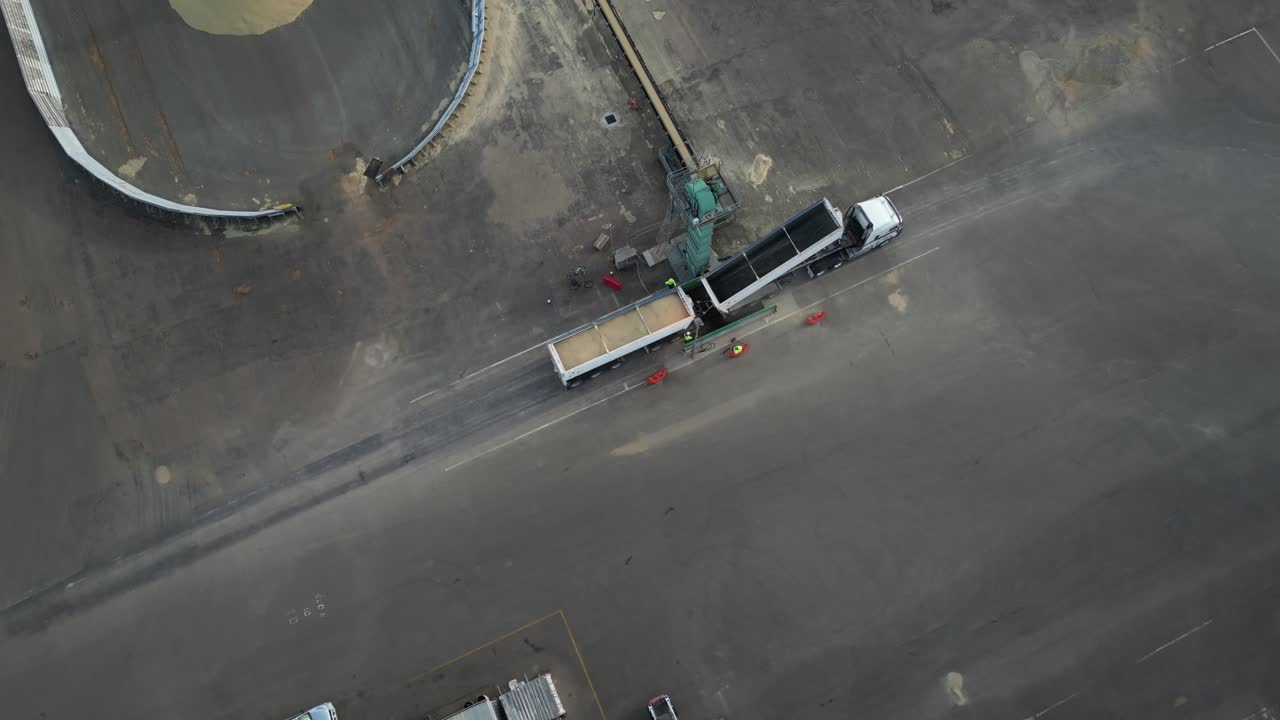 Cargo truck unloading grain in empty grid