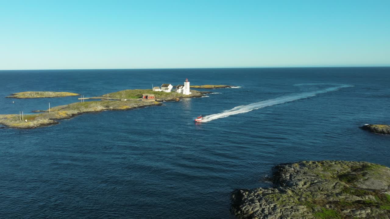 A boat speeds across the calm sea, surrounded by rocky islands and a distant lighthouse. It's a bright midday with clear skies, showcasing the beauty of nature