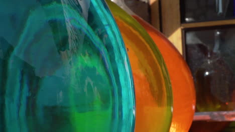 amazing colours through giant perfume jugs in french panning left to right