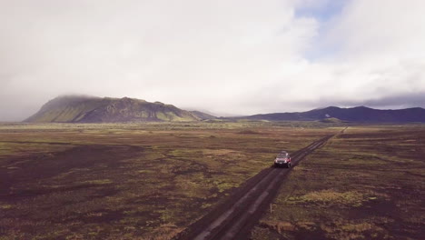 icelandic volcanic landscape with off-road vehicle