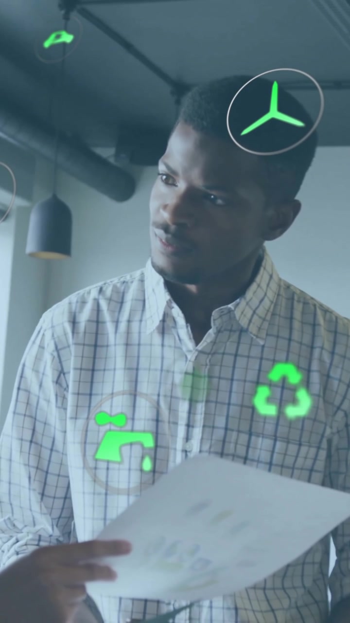 Animation of eco icons over diverse business people in office