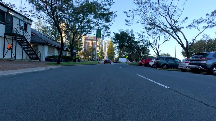 A car travels through a suburban street