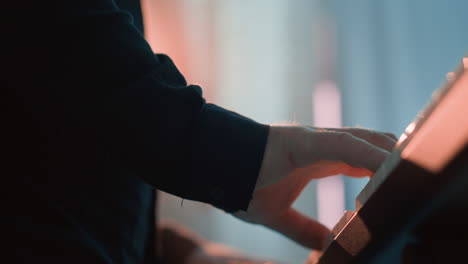 under view of a keyboardist's hand playing a sampler. the focus is on the intricate movements and the tactile interaction with the keys,against a softly lit background