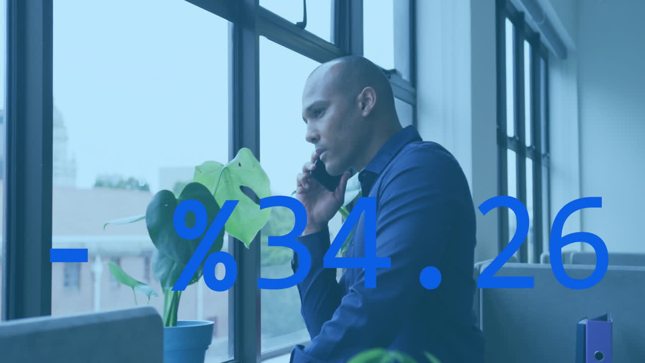 Animation of stock market data processing against biracial man talking on smartphone at office