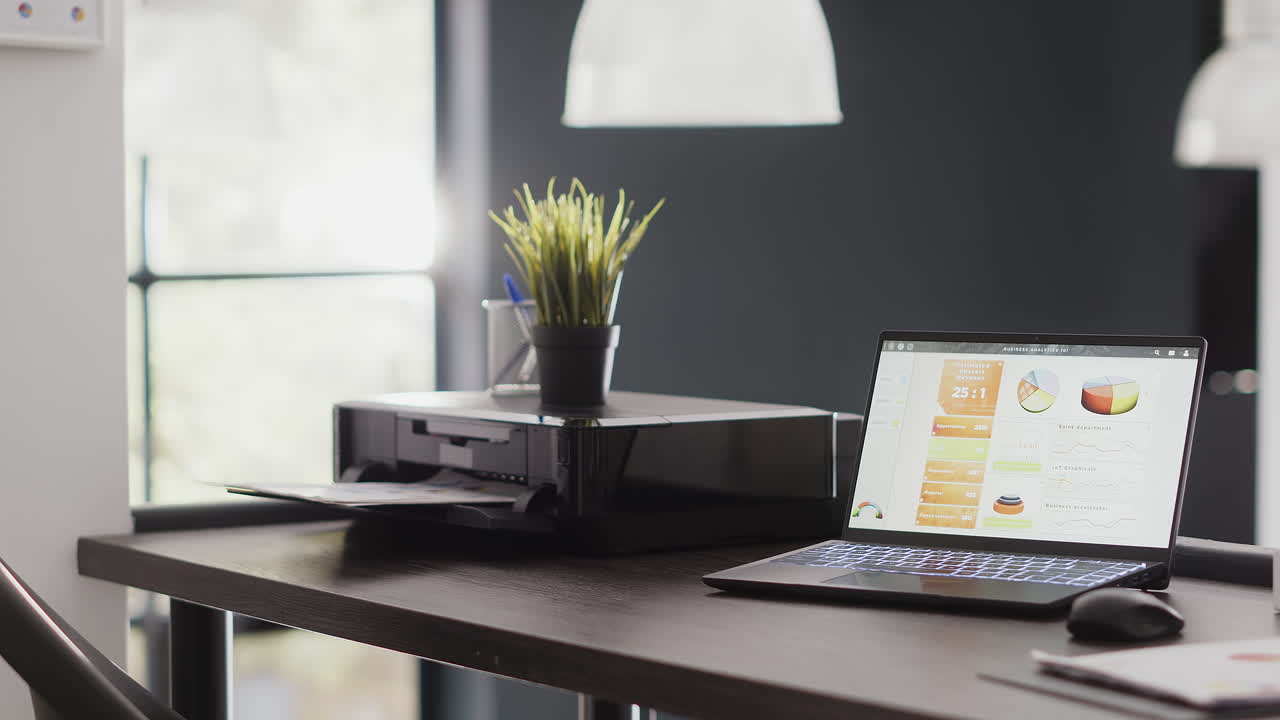 Office workplace with laptop and printer