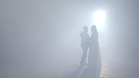 couple dancing in misty studio