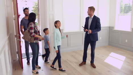 realtor showing family around new home shot on r3d