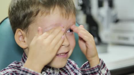little boy checks eyesight in modern ophthalmological clinic. medical examination child.