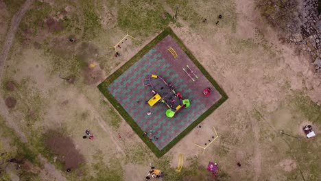 Aerial-top-down-shot-of-kids-playing-games-with-ship-in-playground-park-of-Buenos-Aires