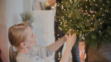 Woman-decorating-Xmas-tree-by-boyfriend