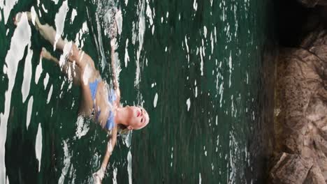 Young-blonde-girl-swims-in-the-Adriatic-Sea-near-Croatia's-Blue-Cave