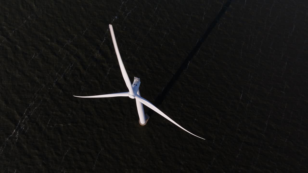 wind turbine on open water, renewable energy. Clean green power. Aerial video.