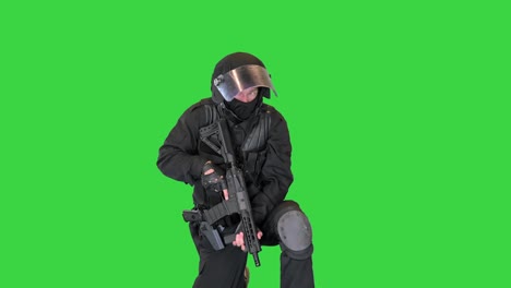 Anti-terrorist unit shooting from sitting position on a Green Screen, Chroma Key
