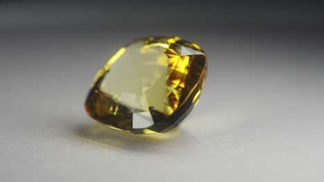 polished yellow gemstone rotates and sparkles