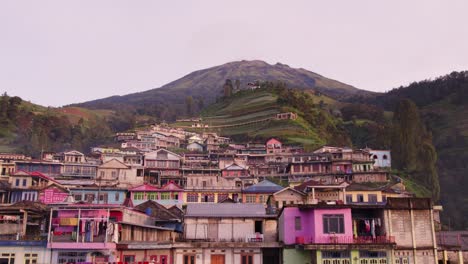 Low-flying-shot-of-Nepal-van-java-colourful-village-Indonesia,-aerial