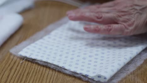 expert hands of seamstress take measures for production of  covid19 masks