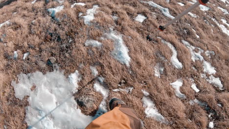 a man descending, sliding winter mountain with stick