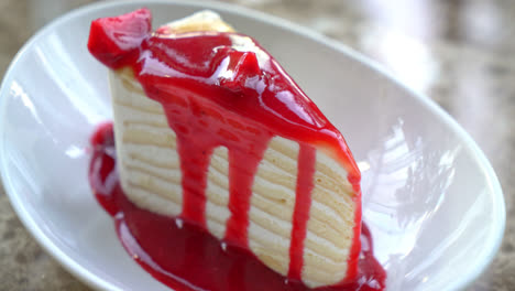 vanilla-crepe-cake-with-raspberry-and-strawberry-sauce-on-plate