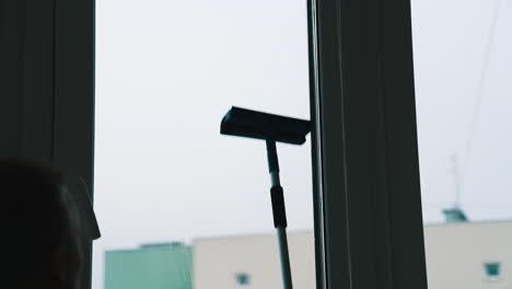 window water cleaning with professional devices. wet glass cleaning.