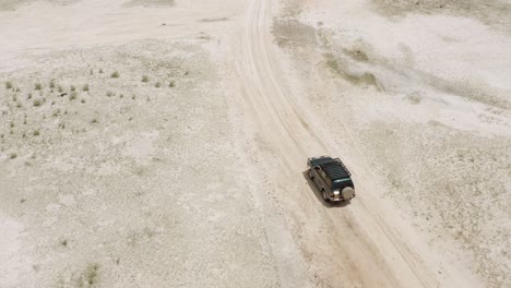 off road vehicle driving through desert