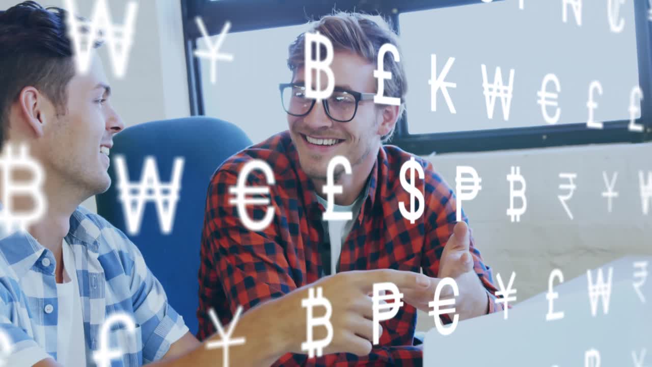 Animation of currency symbols against two diverse men discussing over a laptop at office