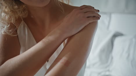 hands massaging nourishing cream at home closeup. gentle girl enjoying beauty
