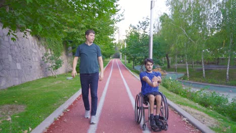 disabled young man drives his wheelchair and does sports.