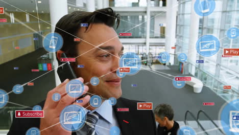 Animation-of-network-of-connections-with-icons-over-caucasian-businessman-using-smartphone