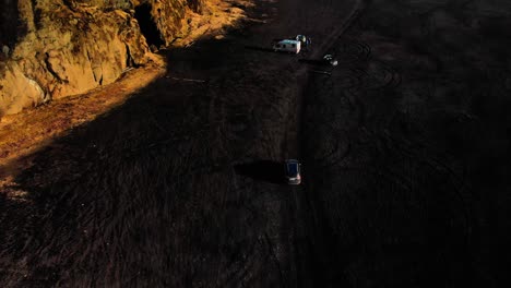 aerial following car top down on iceland's black beach