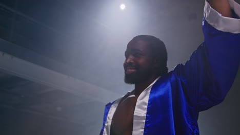 Boxer-Wearing-Gloves-And-Robe-Entering-Ring-Before-Start-Of-Boxing-Match-Waving-And-Greeting-Fans-1