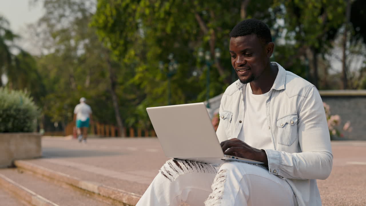 Man Working on Laptop in Park