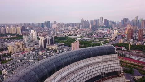 Revealing-Aerial-Shot-of-Hangzhou-Megalopolis-and-its-Highway-on-a-Cloudy-Evening,-China