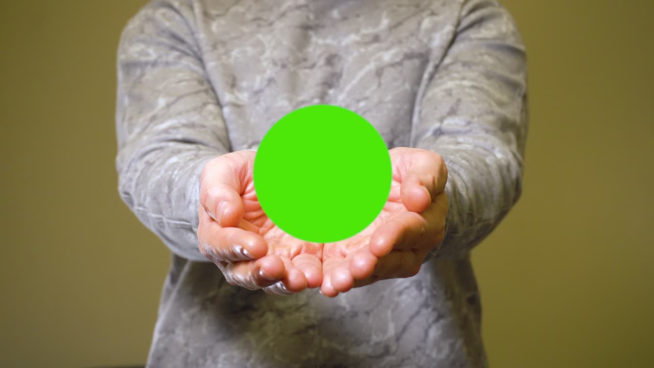 Man opens his palms and show green screen chromakey banner for advert or product