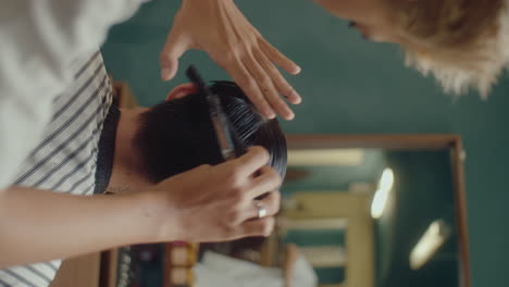 barber cutting hair of a customer with shears