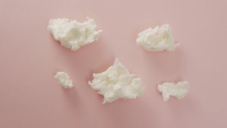 Video-of-marshmallows-pieces-lying-on-pink-surface