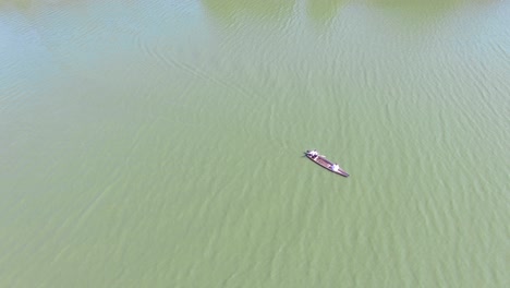 couple relaxing in boat. aerial view of young couple boating on calm river