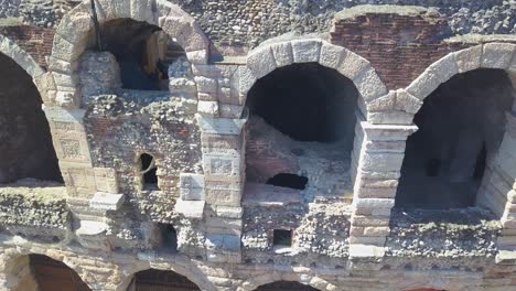 aerial panoramic view of arena di verona, italy. the drone flies near the wall and arches of the arena. a view of the arena and the city opens. 4k vieo.