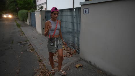 woman walking on a city street at dusk