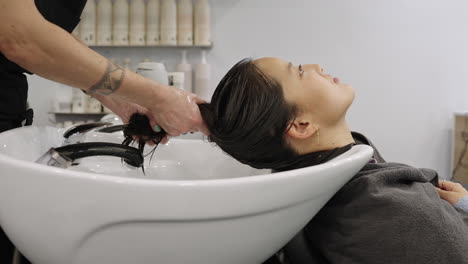 woman getting her hair washed at a salon