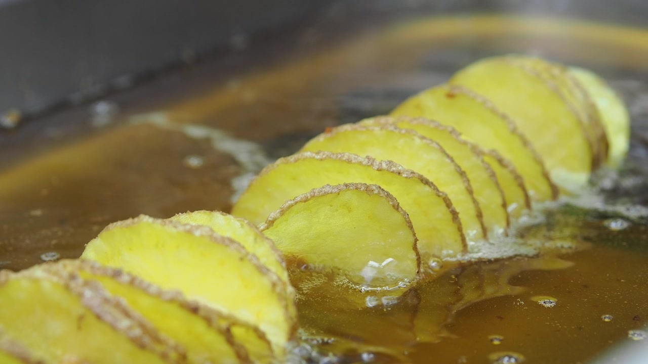 Spiral Potato Slices Deep Frying in Hot Oil
