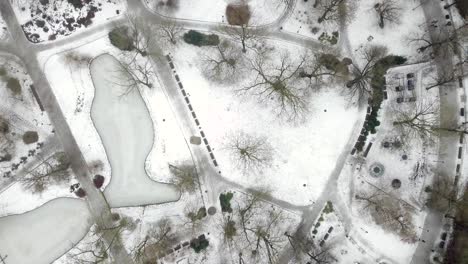 aerial shot of an urban park covered in snow